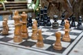 Outdoor chessboard with black and yellow figures with unfocused foreground. Competition and strategy concept. Chess wooden pieces Royalty Free Stock Photo