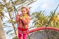 Outdoor child girl portrait enjoying her time on the playground