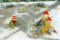 Outdoor children playground with many space for children in winter. Playground equipment in the park. Royalty Free Stock Photo
