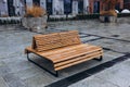 Outdoor city architecture, wooden bench on city street, urban public furniture. Comfortable bench in recreation area Royalty Free Stock Photo