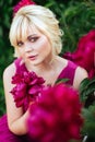 Outdoor close up portrait of beautiful young woman in the blooming garden. Female spring fashion concept Royalty Free Stock Photo