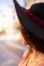 Outdoor close up portrait of beautiful young woman wearing blue cat eye sunglasses and hat posing in the city street. Female Royalty Free Stock Photo