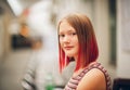 Outdoor portrait of pretty teenage girl with red dyed hair Royalty Free Stock Photo