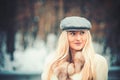 Outdoor close up portrait of young beautiful fashionable woman posing in street. Model wearing grey beret. Female Royalty Free Stock Photo