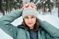 Outdoor close up portrait of young beautiful happy girl, wearing stylish knitted winter hat. Royalty Free Stock Photo