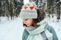 Outdoor close up portrait of young beautiful happy girl, wearing stylish knitted winter hat. Royalty Free Stock Photo