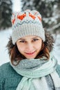 Outdoor close up portrait of young beautiful happy girl, wearing stylish knitted winter hat. Royalty Free Stock Photo