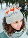 Outdoor close up portrait of young beautiful happy girl, wearing stylish knitted winter hat. Royalty Free Stock Photo