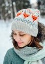 Outdoor close up portrait of young beautiful happy girl, wearing stylish knitted winter hat. Royalty Free Stock Photo