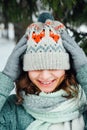 Outdoor close up portrait of young beautiful happy girl, wearing stylish knitted winter hat. Royalty Free Stock Photo