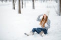 Outdoor close-up portrait of young beautiful happy smiling girl, wearing stylish knitted winter hat and gloves. Model expressing j Royalty Free Stock Photo