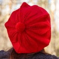 Outdoor close up portrait of young beautiful happy smiling girl wearing french style red knitted beret Royalty Free Stock Photo