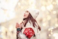 Outdoor close up portrait of young beautiful happy smiling lady holding sparkler, looking up, wearing blue beret, scarf, white Royalty Free Stock Photo