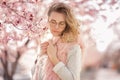 Outdoor close up portrait of young beautiful woman wearing stylish round sunglasses, pink hat, white shirt. Model Royalty Free Stock Photo