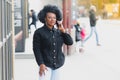 Outdoor close up portrait of young cute happy smiling african american woman with afro hairstyle Royalty Free Stock Photo