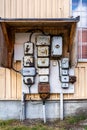 Outdoor closeup facade view of many old rusty worn electrical boxes and wires on building wall. Royalty Free Stock Photo