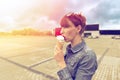 Outdoor closeup fashion portrait of young hipster crazy girl eating ice cream