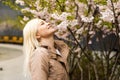 outdoor closeup portrait of a beautiful blonde woman among blossom apple trees Royalty Free Stock Photo