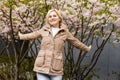 outdoor closeup portrait of a beautiful blonde woman among blossom apple trees Royalty Free Stock Photo