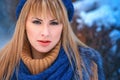 Outdoor closeup portrait of young pretty blonde girl walking in the cold winter weather in the park. Sensual long-haired Royalty Free Stock Photo