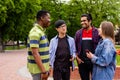 Outdoor communication between joyful multiracial college students Royalty Free Stock Photo