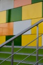 Steps and shoes from stainless steel on the background of a multi colored fa ade of cubes Royalty Free Stock Photo