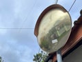 Outdoor convex safety mirror hanging on metal post
