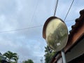 Outdoor convex safety mirror hanging on metal post