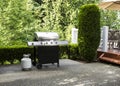 Outdoor cooker on House concrete patio with home deck on side Royalty Free Stock Photo