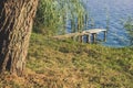 Outdoor country side nature local landscape scenery place with poor small wooden pier near river shore line Royalty Free Stock Photo