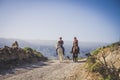 Outdoor cowboy life couple ride horses at the mountain enjoying excursion in the nature together - alternative vacation travel
