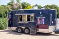 An outdoor dark blue food truck