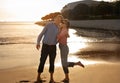 Outdoor Date. Happy mature couple laughing together and embracing at sandy beach Royalty Free Stock Photo