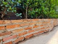 Outdoor decorated red bricks potted without plaster