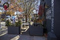 An outdoor dining area at the Decatur Square with gorgeous red and yellow autumn trees and lush green trees