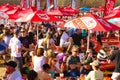 Outdoor dining area populated by a large gathering of people