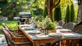 Outdoor dining table setting with rustic decor and barbecue grill Royalty Free Stock Photo