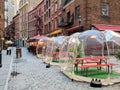 Outdoor dining tables in bubbles along Stone Street during the coronavirus pandemic in downtown Manhattan, New York City Royalty Free Stock Photo