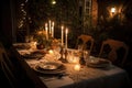 outdoor dinnertime scene with candlelight, fine china, and elegant table setting Royalty Free Stock Photo