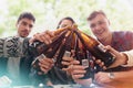 Outdoor, drinking and friends with beer, toast and cheers with party and restaurant with social gathering. People Royalty Free Stock Photo