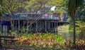 Outdoor eating on deck of cafe on stilts overlooking lake at Mount Penang Gardens, New South Wales, Australia