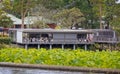 Outdoor eating on deck of cafe on stilts overlooking lake at Mount Penang Gardens, New South Wales, Australia