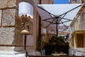 Outdoor eating of a restaurant or cafe in Taormina, Sicily. Decorative lamps and set tables for dining