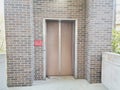 Outdoor elevator with brick wall out of service