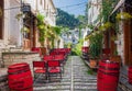 Outdoor empty coffee and restaurant terrace with colorful tables and chairs. Old fashioned cafe terrace in Berat