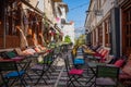 Outdoor empty coffee and restaurant terrace with colorful tables and chairs. Old fashioned cafe terrace in Berat