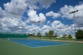 Outdoor empty tennis court with blue sky