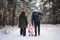 Outdoor family activities for happy christmas winter holidays. Happy father and mother playing with little baby toddler Royalty Free Stock Photo
