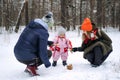 Outdoor family activities for happy winter holidays. Happy father and mother playing with little baby toddler girl Royalty Free Stock Photo