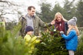 Outdoor Family Choosing Christmas Tree Together Royalty Free Stock Photo